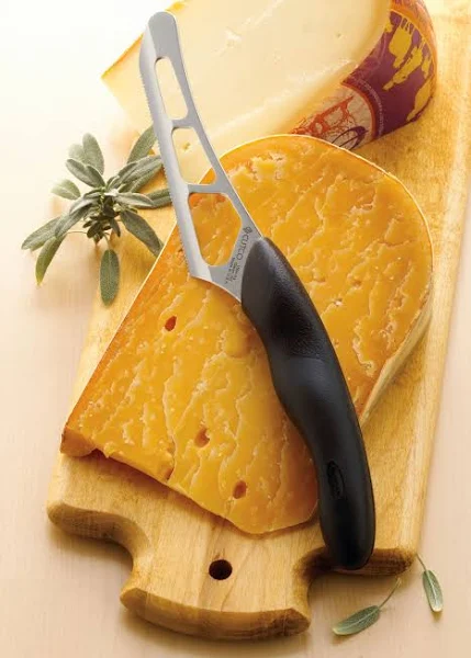 Model 1504 CUTCO Cheese Knife w/ 5.5" Micro-D® serrated edge blade & 5" black Soft Comfort-grip handle. Holes on blade’s surface helps cheese fall away during cutting.