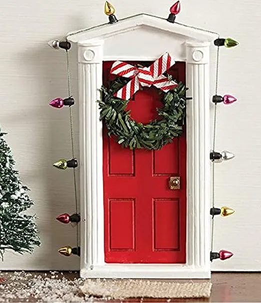 Standing miniature dimensional door surrounded with “lights” and tiny faux wreath with bow allows special entry for fairies and elves